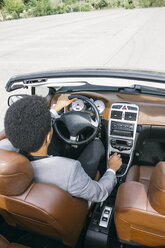 Young black man driving convertible - ABZF000047