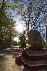 Little girl walking on forest track at twilight - JFEF000670