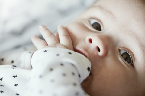 Close-up of baby with finger in mouth stock photo