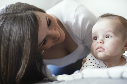 Young mother looking at baby stock photo