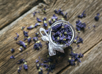 Glass jar and sweet violets on wood - MGOF000232