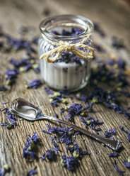 Glass jar and sweet violets on wood - MGOF000233