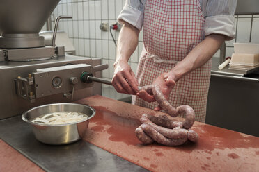 Preparation of smoked sausage, Butcher filling sausage casing - PAF001410