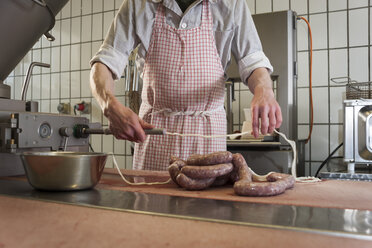 Preparation of smoked sausage, Butcher filling sausage casing - PAF001411