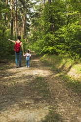 Father and daughter hiking in forest - UUF004263