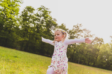 Carefree girl running on meadow - UUF004314