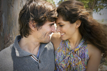 South Africa, happy couple facing each other at a tree - TOYF000669