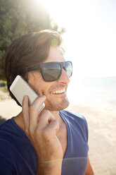 South Africa, man on cell phone at the coast - TOYF000800