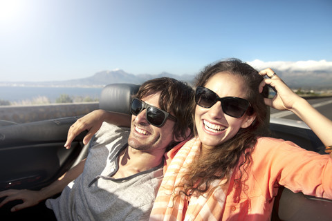 South Africa, happy couple in convertible on coastal road stock photo