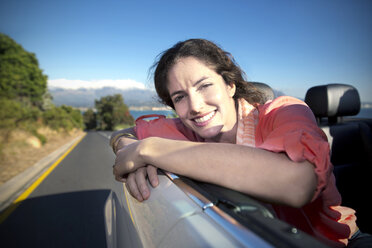 South Africa, happy woman in convertible on coastal road - TOYF000700