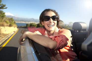 South Africa, happy woman in convertible on coastal road - TOYF000701