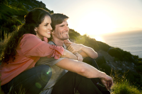 Südafrika, Paar genießt die Aussicht auf die Küste bei Sonnenuntergang, lizenzfreies Stockfoto