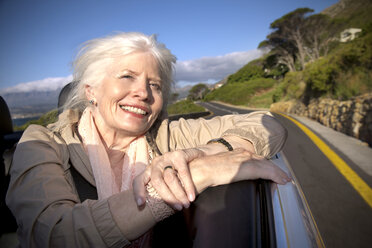 South Africa, portrait of happy senior woman sitting in a convertible - TOYF000717