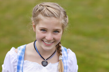 Germany, Luneburger Heide, portrait of smiling blond girl wearing dirndl - HRF000031