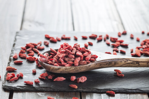 Holzlöffel mit Goji-Beeren auf einer Schiefertafel, Superfood - SBDF001888