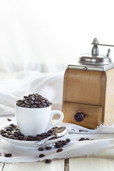 Old coffee mill and coffee cup filled with coffee beans - SBDF001905
