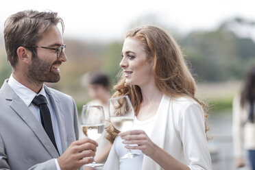 Couple toasting on terrace of a restaurant - ZEF005433