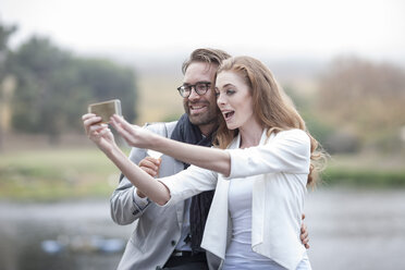 Couple taking a selfie with smartphone - ZEF005096