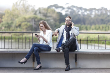 Couple with smartphones on a terrace - ZEF005101