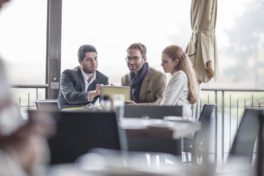 Three people having a meeting at restaurant - ZEF005114