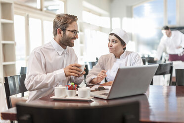 Restaurant chef and manager discussing menu - ZEF005164