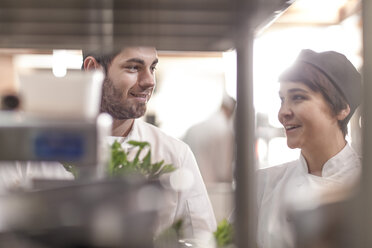 Male and female chef with fresh ingredients in restaurant kitchen - ZEF005186