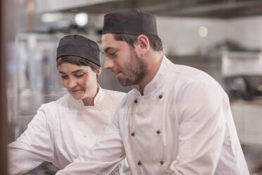 Two chefs working together in kitchen - ZEF005178