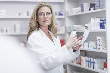 Pharmacist helping clients at pharmacy dispensary - ZEF005811
