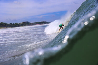 Indonesia, Bali, Surfer in the tube getting barreled - KNTF000036
