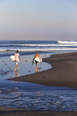 Indonesia, Bali, Surfers on the beach stock photo