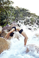 Seychelles, woman bridge position at seafront - ABF000622