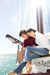 Happy young couple on a sailing ship - TOYF000881