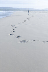 South Africa, Cape Town, young woman standing on the beach looking at distance - ZEF005239