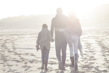 South Africa, Cape Town, back view of family walking on the beach at backlight - ZEF005251