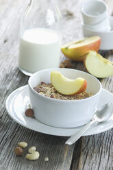 Bowl of granola with slice of an apple - ASF005619