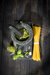 Preparing pesto alla genovese with mortar, uncooked spaghetti - MAEF010601