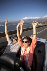 South Africa, happy couple driving in a convertible - TOYF000984