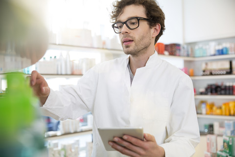Portrait of pharmacist doing inventory control with digital tablet stock photo