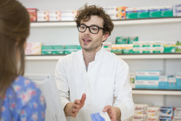 Portrait of pharmacist advising female customer - FKF001083