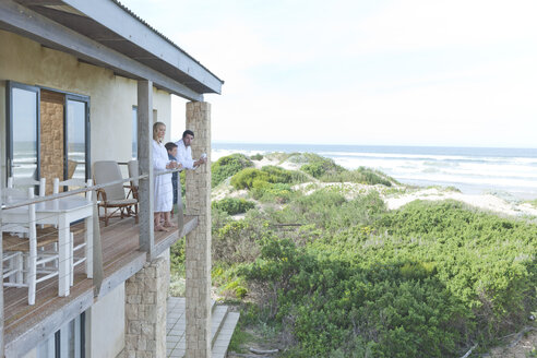 Family on patio of beach house - ZEF005340