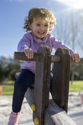 Spain, Gijon, little girl sitting on a rocker - MGOF000250