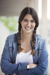 Portrait of smiling young woman with braids - RBF002885