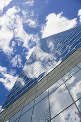 Spain, Madrid, glass facade of skyscraper with reflection of clouds - ABZF000073