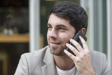 Lächelnder Mann am Mobiltelefon - ZEF007042