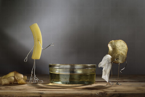 French fry and potato chip undressed next to bathtub - NIF000047