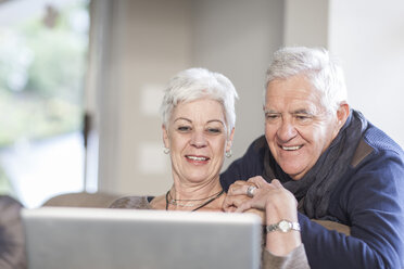 Senior couple looking together at laptop - ZEF005502