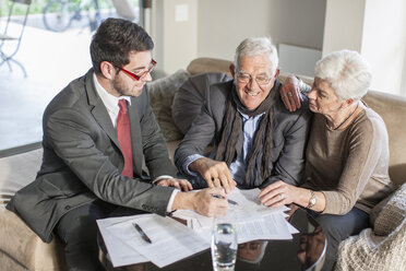 Senior couple at home having a meeting with salesman - ZEF005527