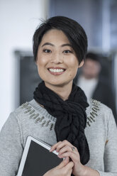 Portrait of casual businesswoman holding digital tablet - ZEF005631