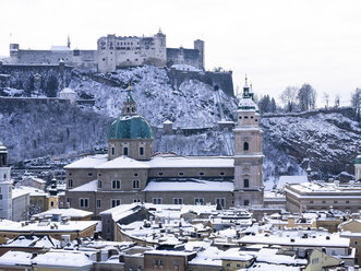 Austria, Salzburg State, Salzburg, Old town, View to Salzburg Cathedral and Hohensalzburg Castle in winter - AMF004055