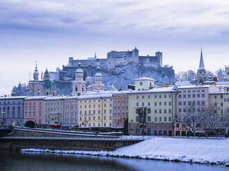 Austria, Salzburg, Old town, Salzach river, Hohensalzburg Fortress and churches in winter - AMF004056